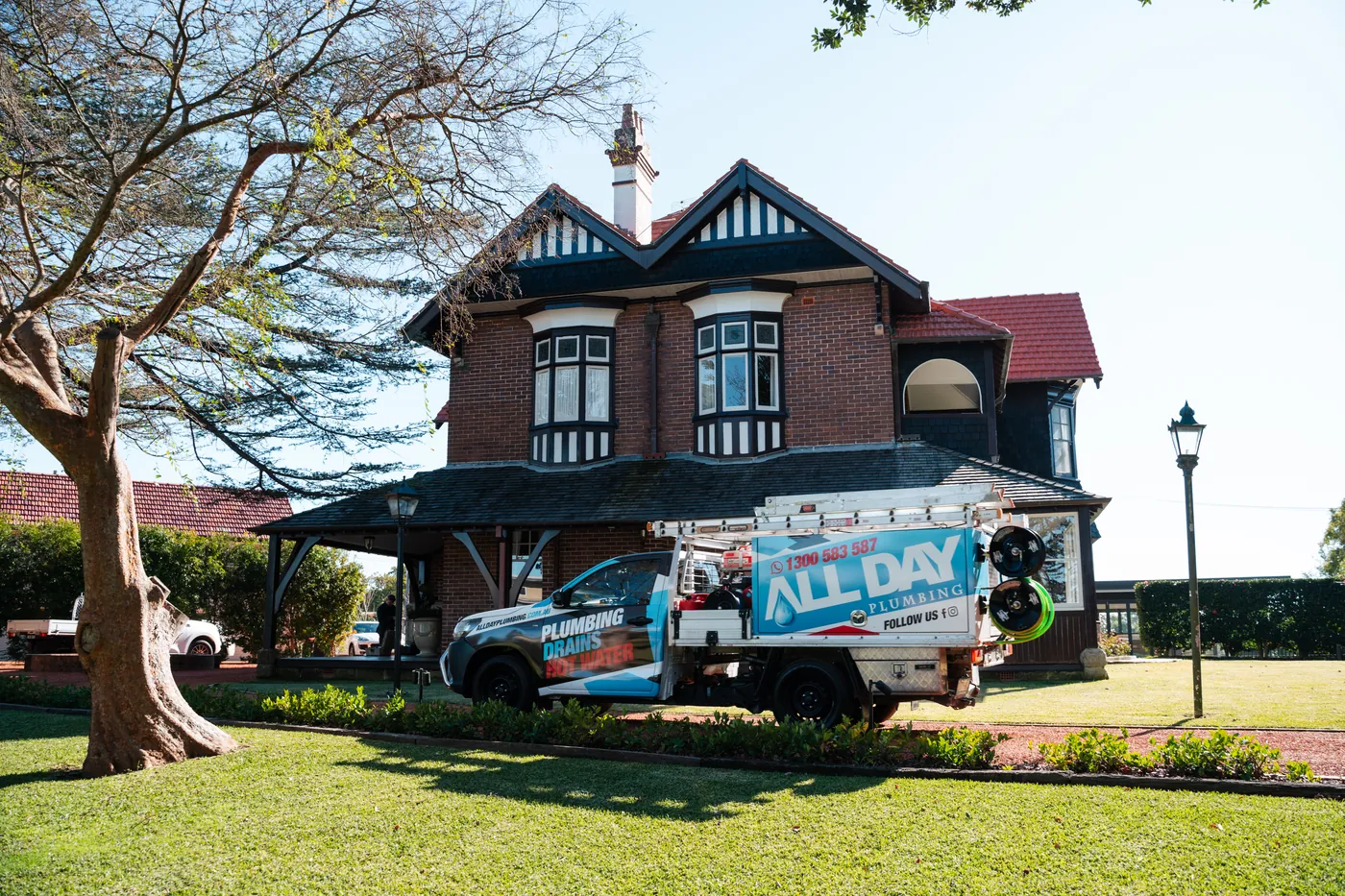 An All Day Plumbing service vehicle outside a Sydney home.